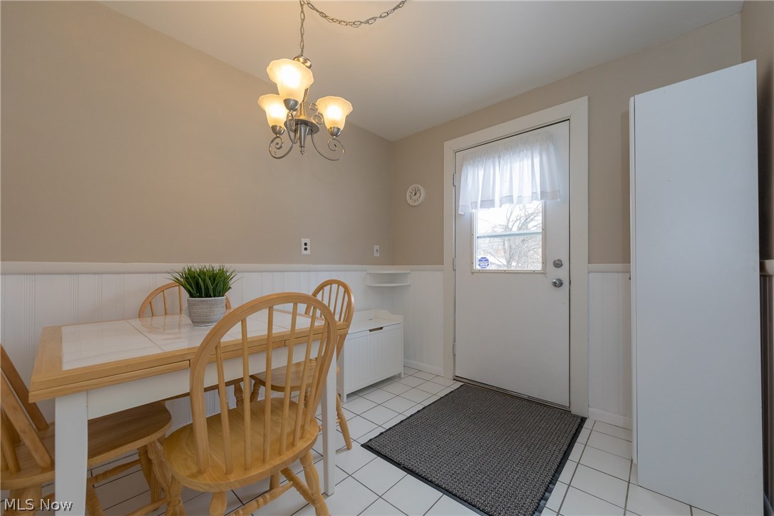 2432 Saybrook Road Cleveland, OH 44118 - Photo 15 of 32 The dining area of the Kitchen, showing the back door which leads to the large wooden deck outside. This tiled area also serves as a convenient mud room