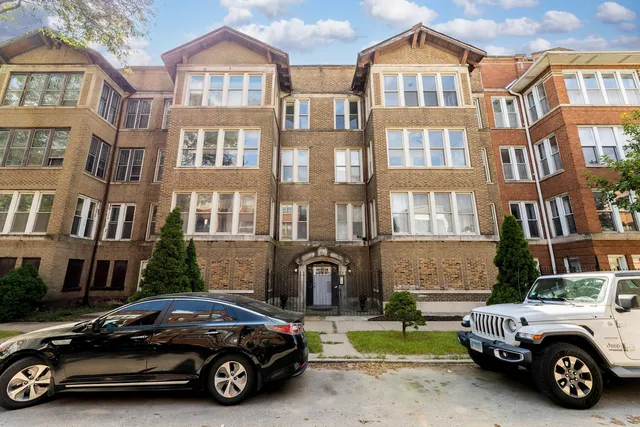 a car parked in front of a brick house