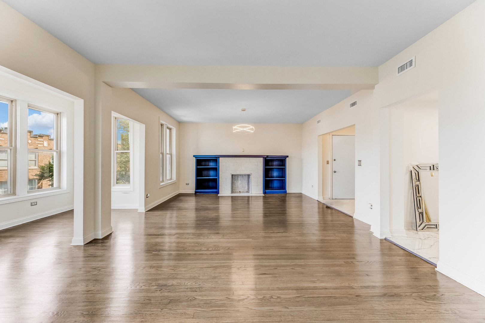 4722 South Ingleside Avenue, Unit 3N Chicago, IL 60615 - Photo 5 of 12 a view of an empty room with wooden floor and a window