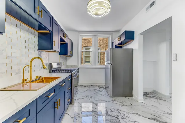 a kitchen with stainless steel appliances granite countertop a refrigerator and a sink