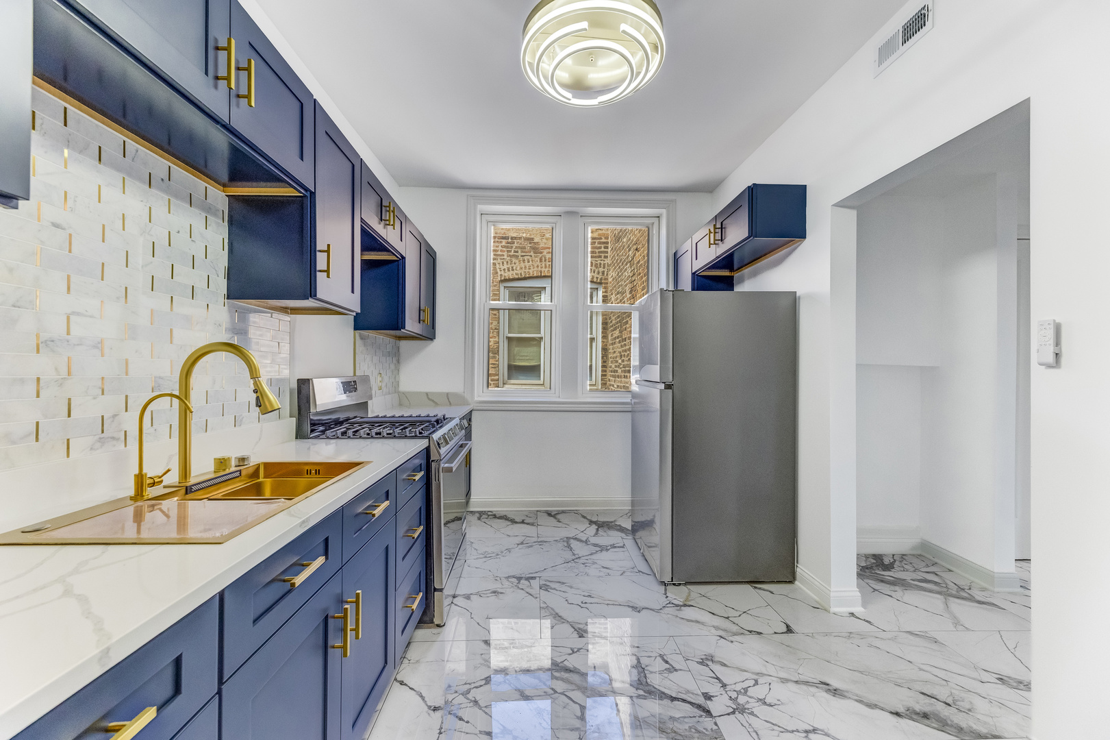 4722 South Ingleside Avenue, Unit 3N Chicago, IL 60615 - Photo 6 of 12 a kitchen with stainless steel appliances granite countertop a refrigerator and a sink