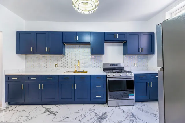 a kitchen with stainless steel appliances granite countertop a stove and a sink