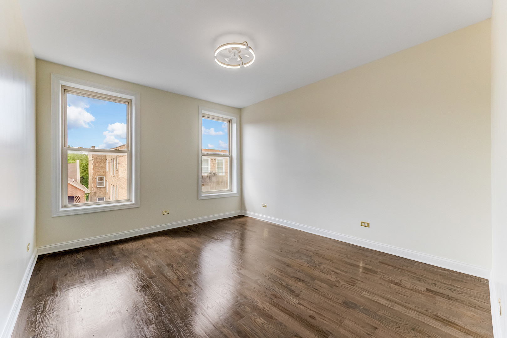 4722 South Ingleside Avenue, Unit 3N Chicago, IL 60615 - Photo 8 of 12 an empty room with wooden floor and windows