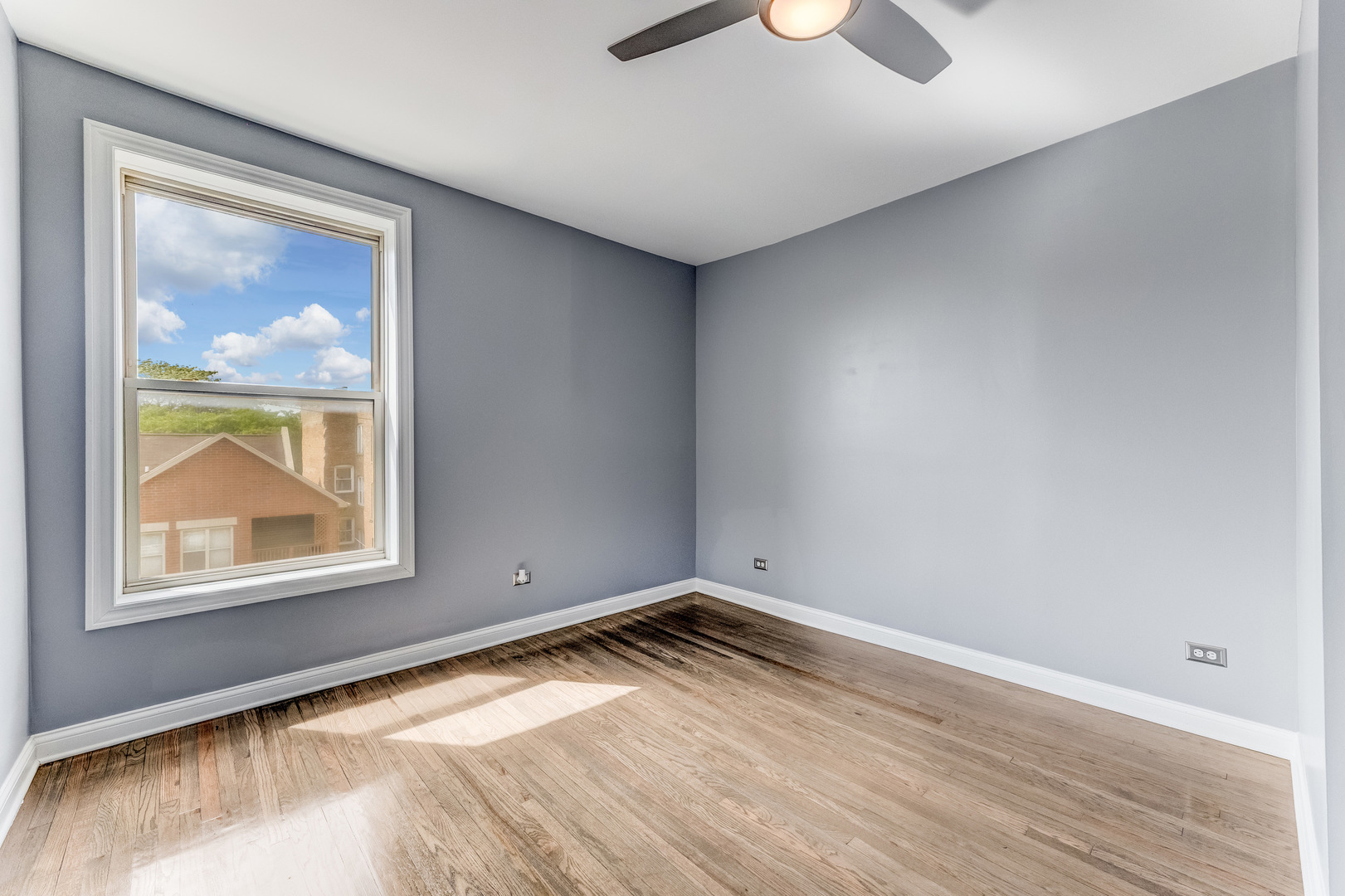 4722 South Ingleside Avenue, Unit 3N Chicago, IL 60615 - Photo 10 of 12 a view of empty room with window and wooden floor