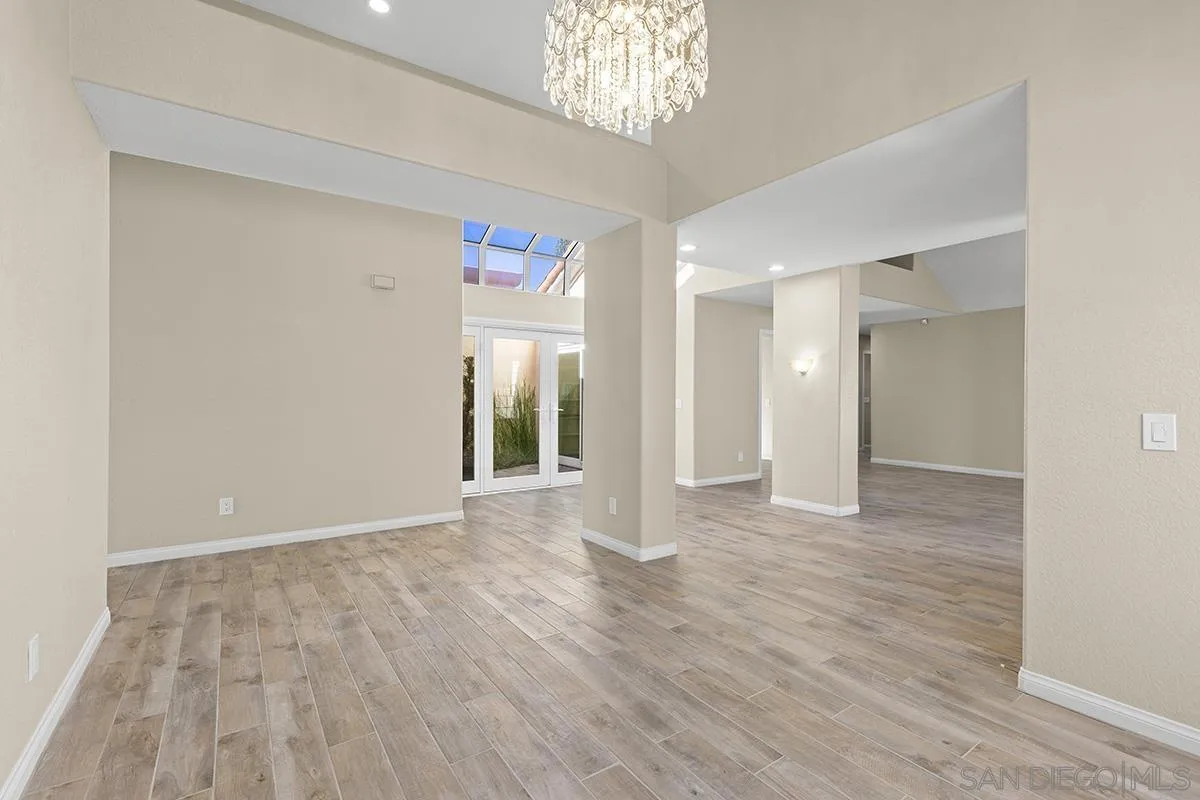 12071 Caminito Corriente San Diego, CA 92128 - Photo 12 of 51 wooden floor in an empty room with a window