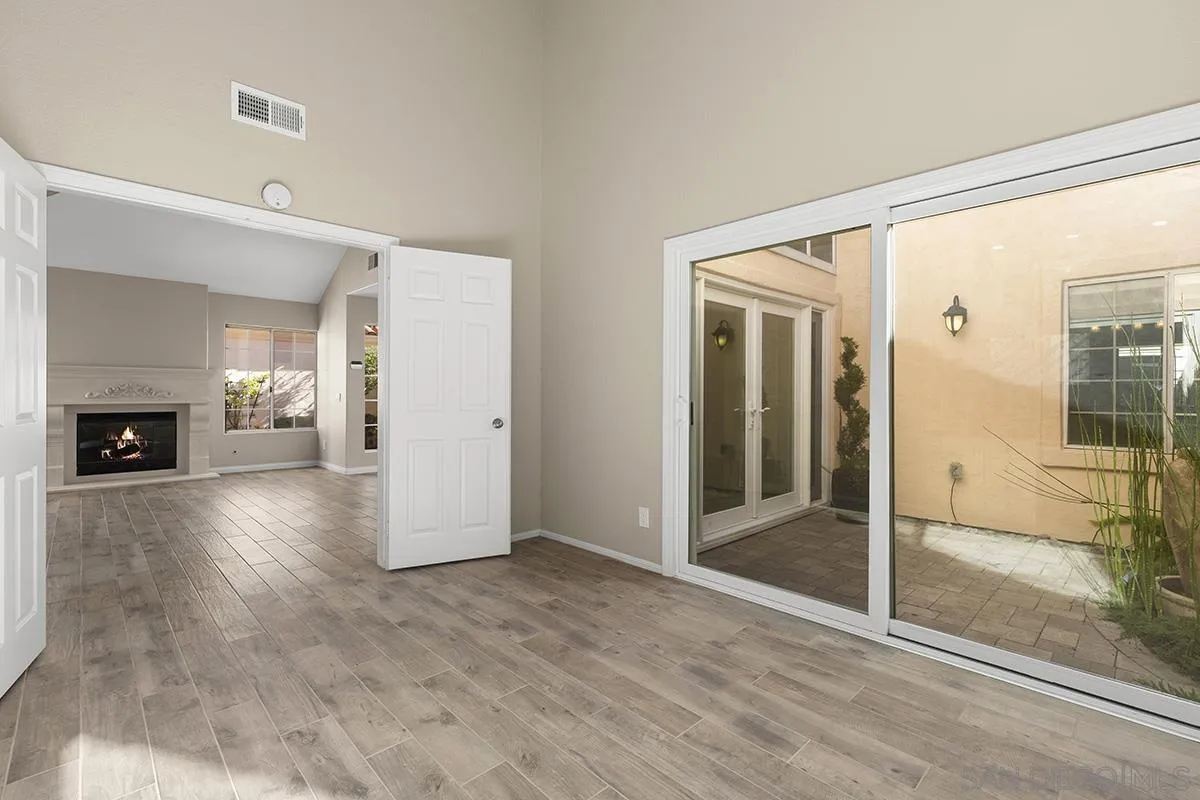 12071 Caminito Corriente San Diego, CA 92128 - Photo 14 of 51 view of empty room with wooden floor and fireplace