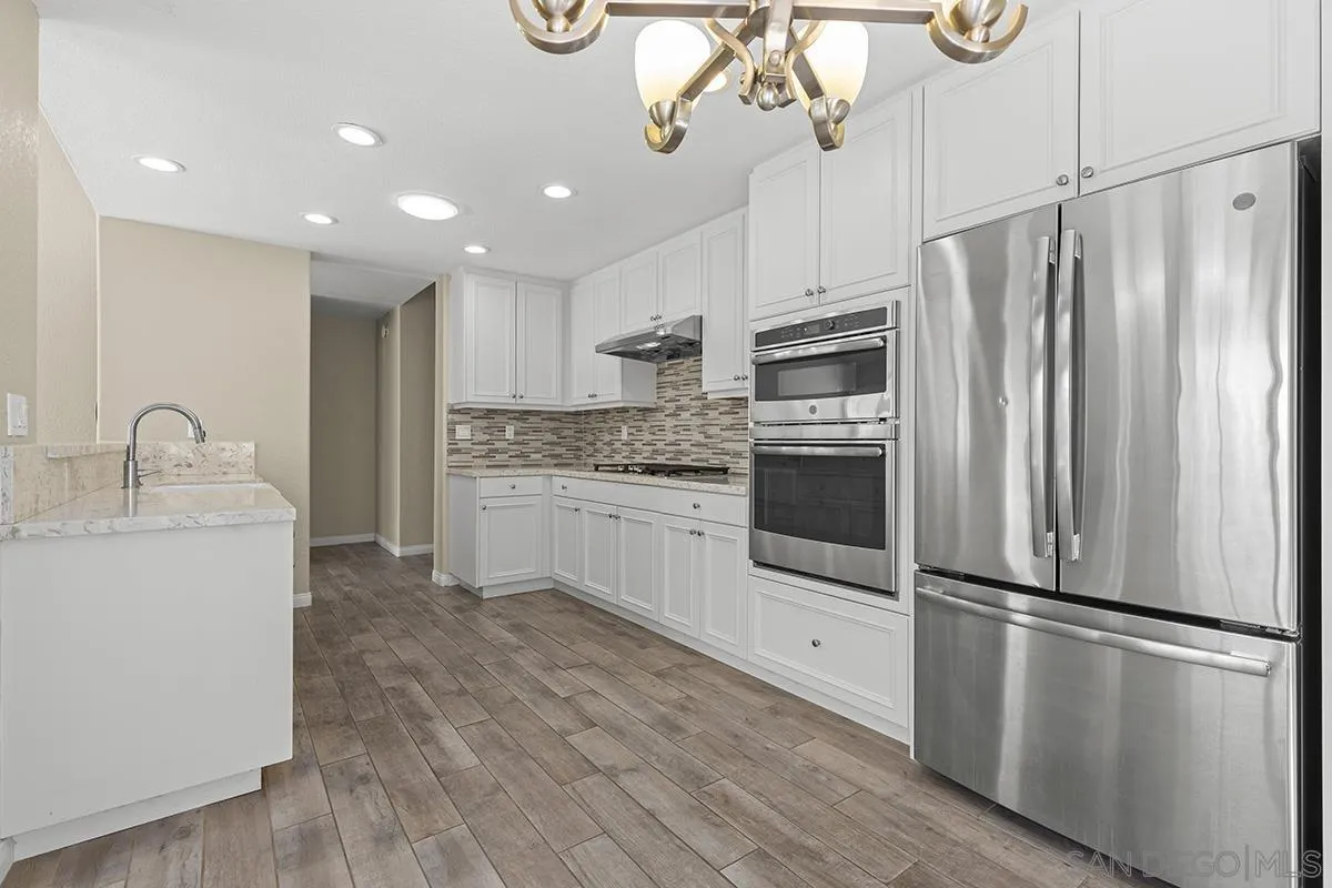 12071 Caminito Corriente San Diego, CA 92128 - Photo 18 of 51 a kitchen with stainless steel appliances a refrigerator sink and microwave