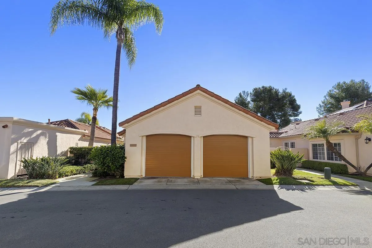12071 Caminito Corriente San Diego, CA 92128 - Photo 2 of 51 a view of a house with a yard and palm trees