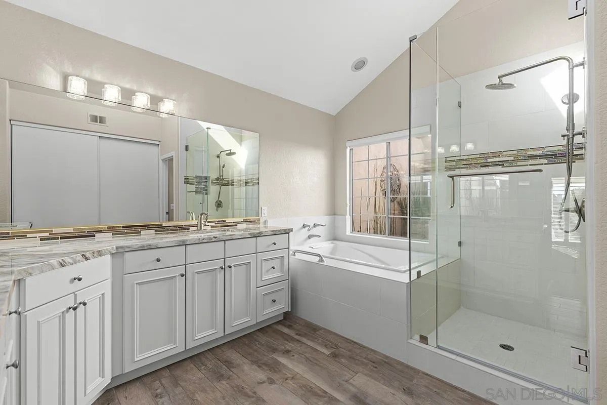 12071 Caminito Corriente San Diego, CA 92128 - Photo 25 of 51 a bathroom with a granite countertop sink mirror and double