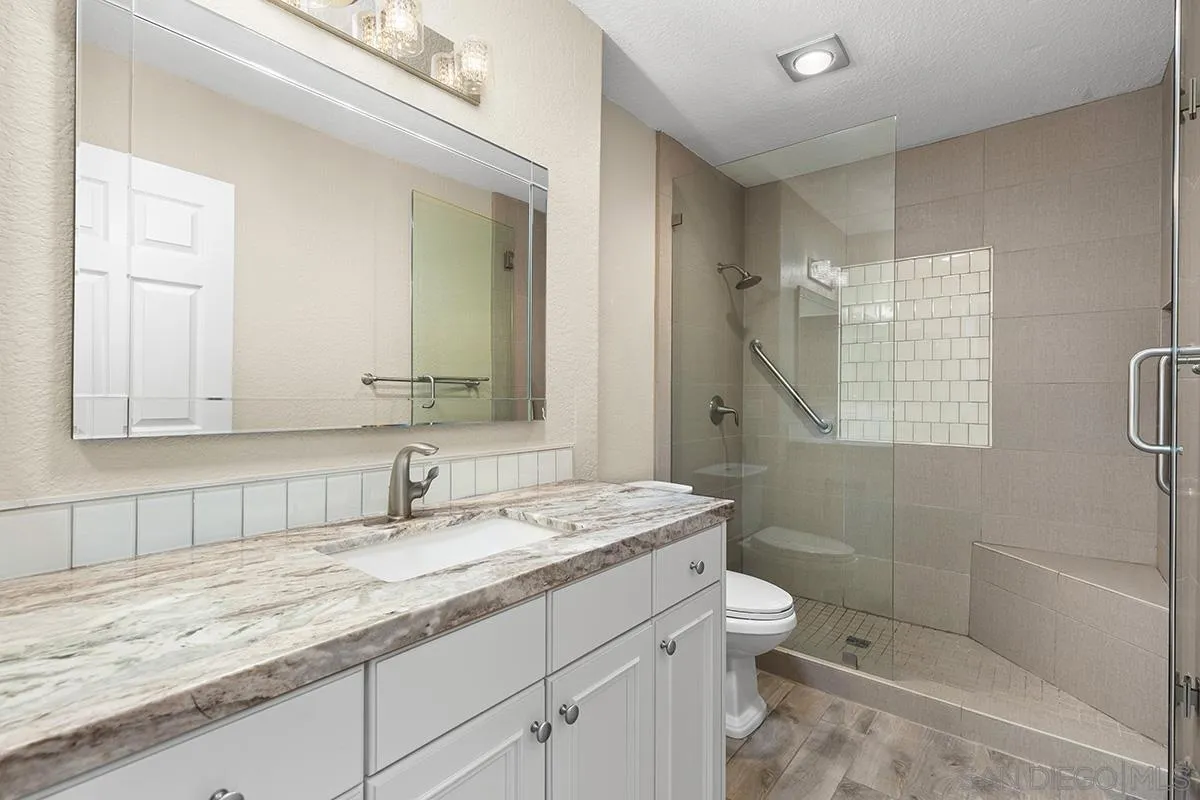 12071 Caminito Corriente San Diego, CA 92128 - Photo 30 of 51 a bathroom with a granite countertop sink a toilet and shower