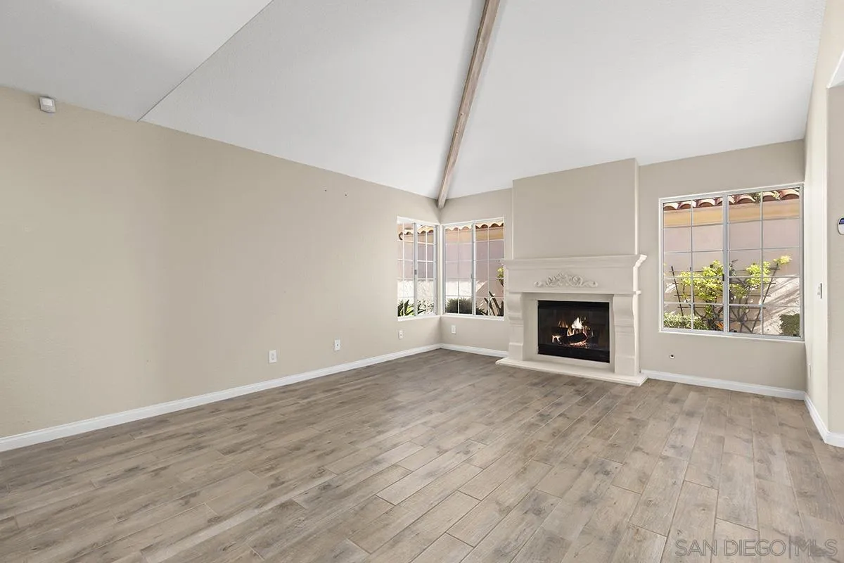 12071 Caminito Corriente San Diego, CA 92128 - Photo 9 of 51 a view of empty room with fireplace and wooden floor