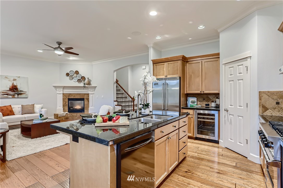 905 South 38th Court Renton, WA 98055 - Photo 15 of 33 a kitchen with stainless steel appliances kitchen island granite countertop a stove and a sink