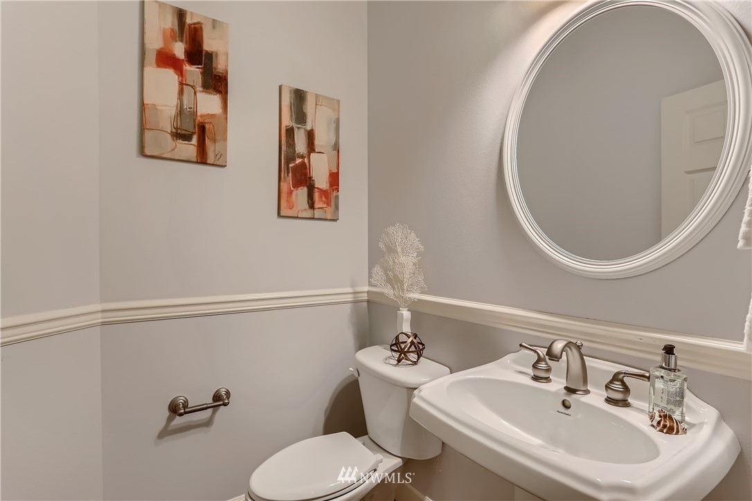 905 South 38th Court Renton, WA 98055 - Photo 18 of 33 a bathroom with a sink mirror and toilet