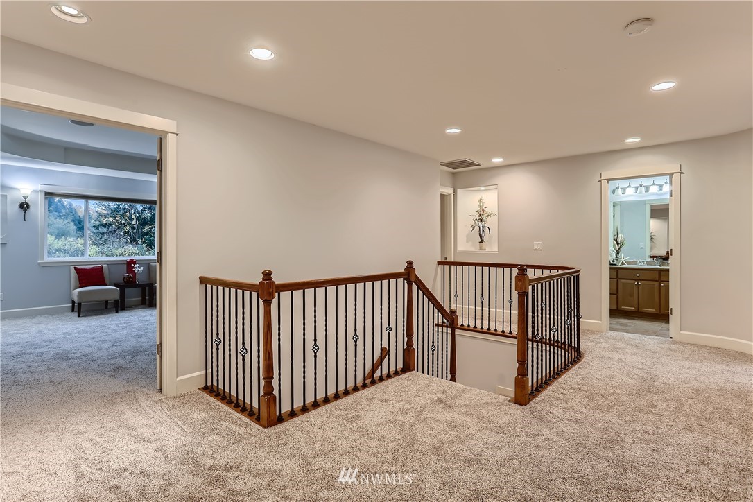 905 South 38th Court Renton, WA 98055 - Photo 19 of 33 a view of a hallway with wooden floor and windows