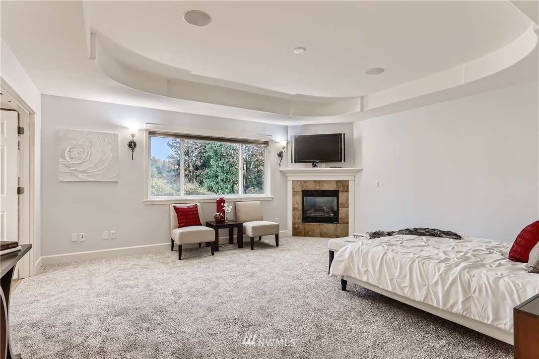905 South 38th Court Renton, WA 98055 - Photo 20 of 33 a bedroom with a bed and a fireplace