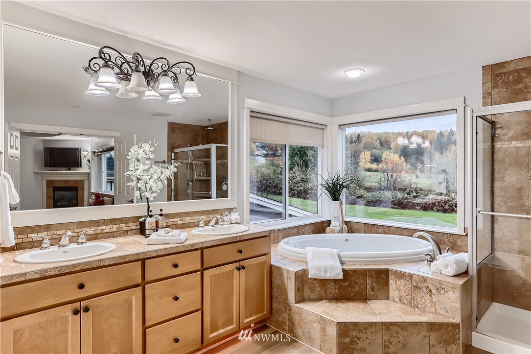 905 South 38th Court Renton, WA 98055 - Photo 23 of 33 a bathroom with a granite countertop sink and a large mirror