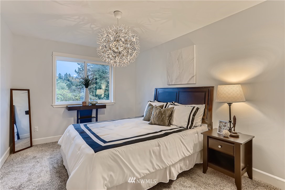 905 South 38th Court Renton, WA 98055 - Photo 26 of 33 a bedroom with a bed and a chandelier