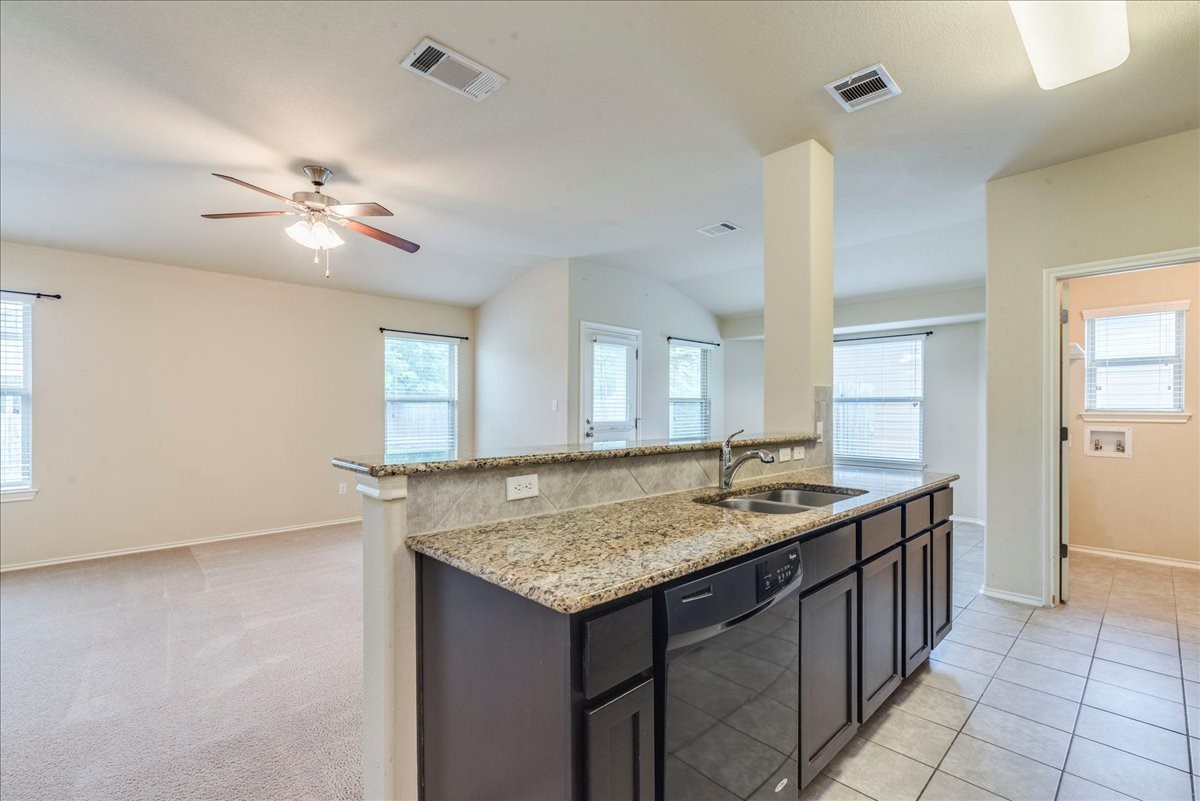 1061 Violet Lane Kyle, TX 78640 - Photo 7 of 34 Kitchen island with breakfast bar and plenty of countertop and storage