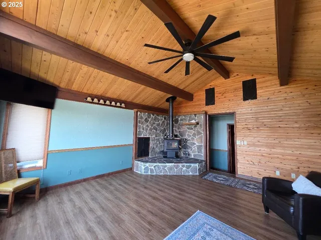 a kitchen with stainless steel appliances kitchen island granite countertop a refrigerator and a stove