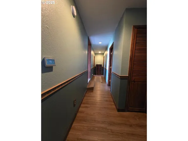 a bedroom with a bed window and a flat screen tv