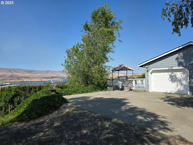 a view of a house with a yard and a garage