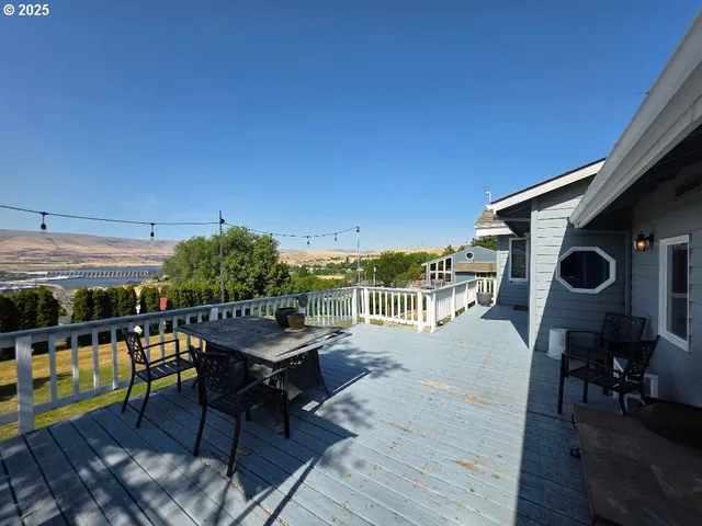 a view of a balcony with yard