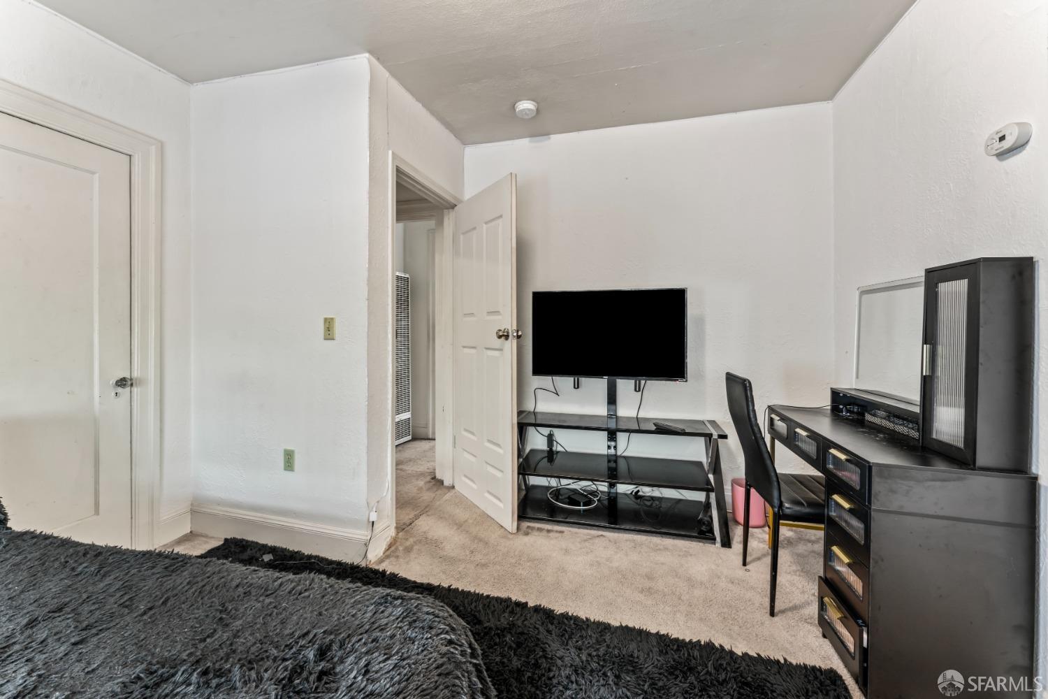 1646 Parker Street Berkeley, CA 94703 - Photo 17 of 33 a bedroom with a bed and a flat screen tv