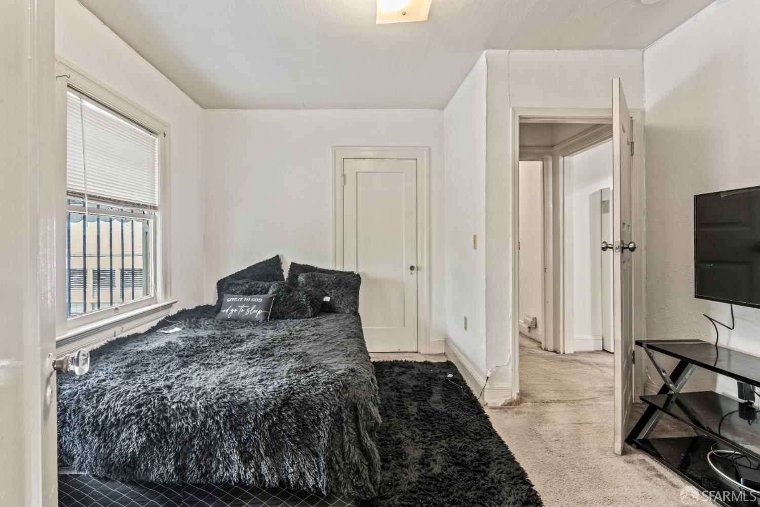 1646 Parker Street Berkeley, CA 94703 - Photo 18 of 33 a bedroom with a bed and a flat tv screen on a dresser