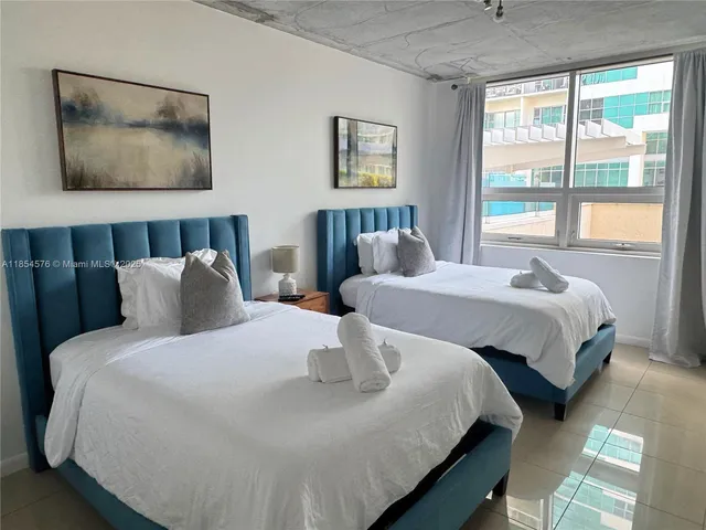 a bedroom with double bed and a window