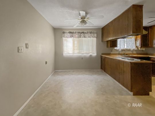 312 North Norma Street Ridgecrest, CA 93555 - Photo 4 of 18 a view of an empty room with a kitchen