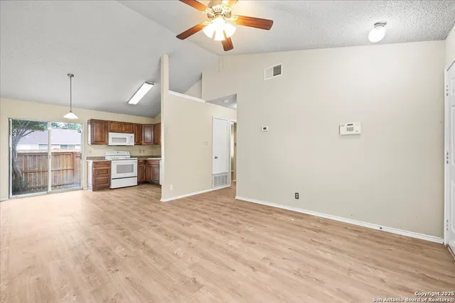 a view of a kitchen with a sink and a refrigerator