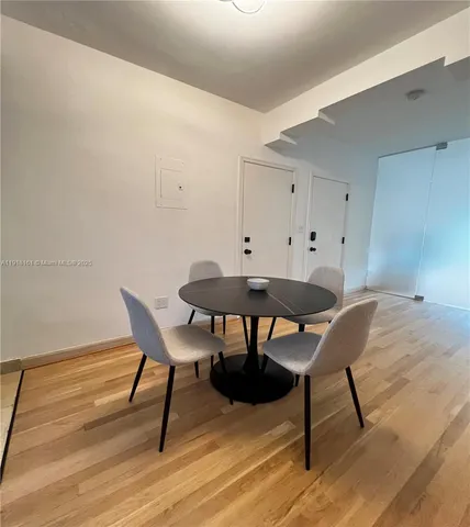 a dining room with furniture and wooden floor