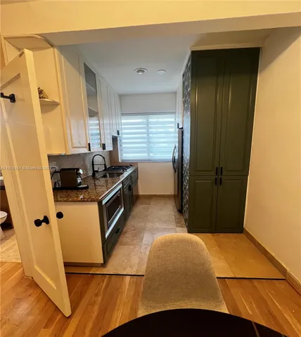 a kitchen with a refrigerator and a stove