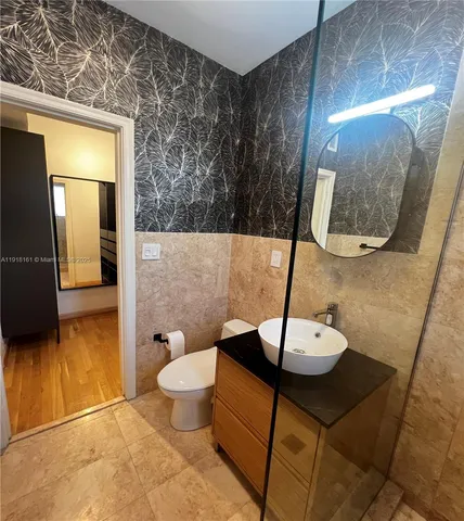 a living room with furniture and a mirror