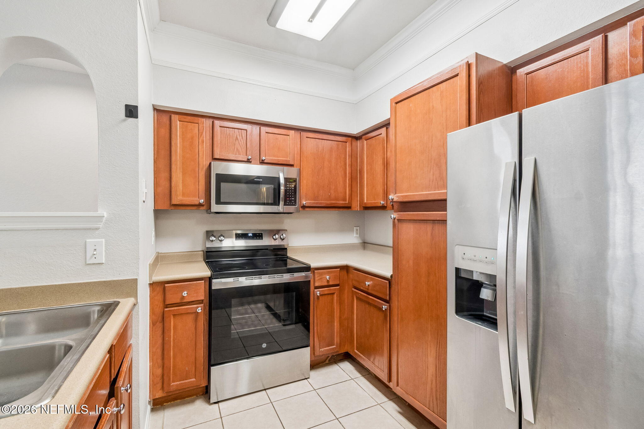 8550 Touchton Road, Unit 511 Jacksonville, FL 32216 - Photo 23 of 63 a kitchen with a refrigerator sink and stove