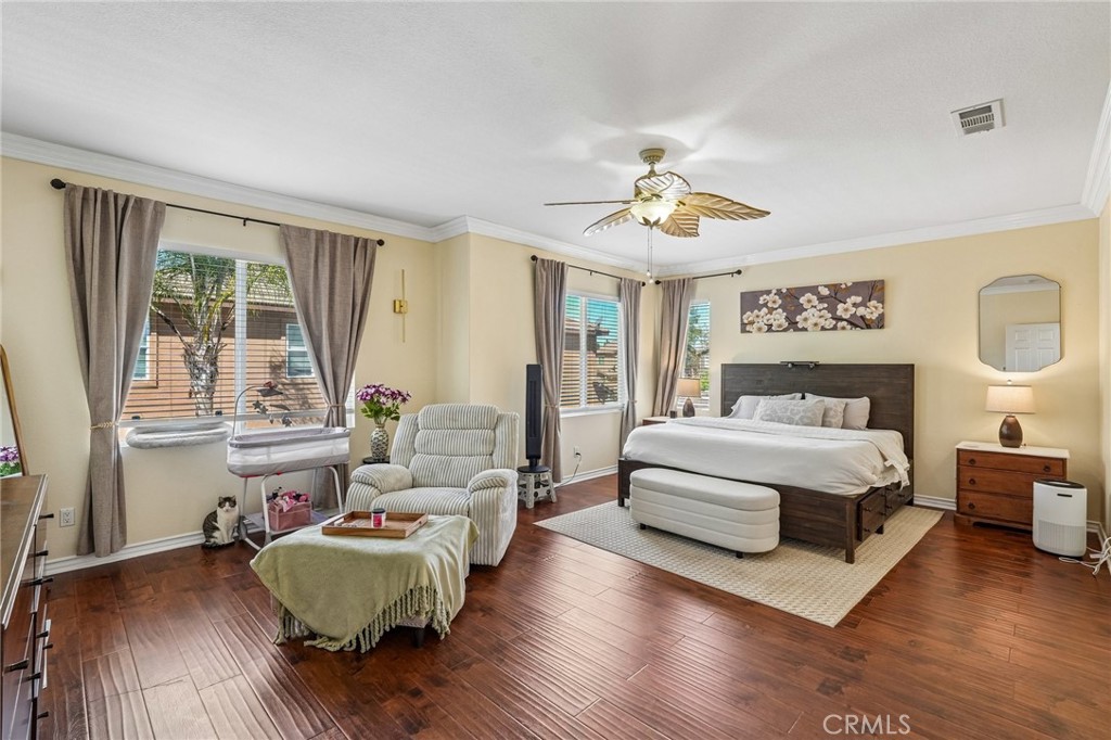 46101 Sharon Street Temecula, CA 92592 - Photo 20 of 34 a spacious bedroom with a large bed a couch and large window