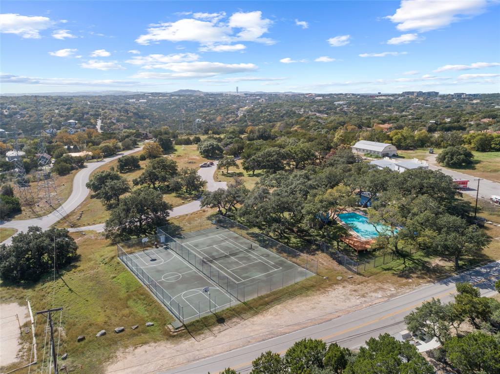 2210 Red Fox Road Austin, TX 78734 - Photo 37 of 40 An aerial perspective reveals a vibrant community with recreational courts and a welcoming pool.