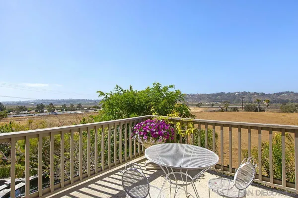 a view of a chairs and table on the balcony