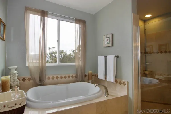 a bath tub sitting in a bathroom next to a window