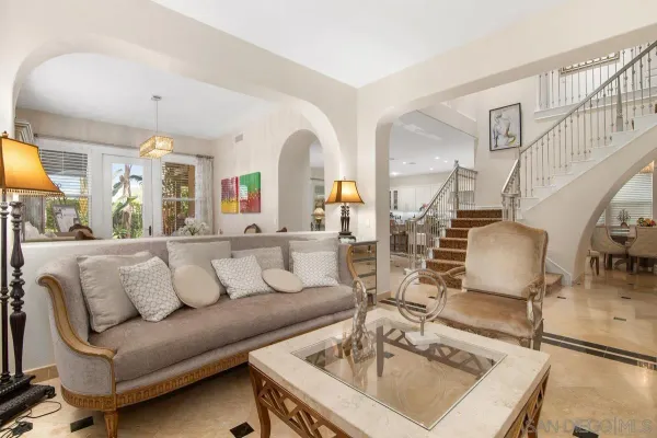 a living room with furniture and a chandelier
