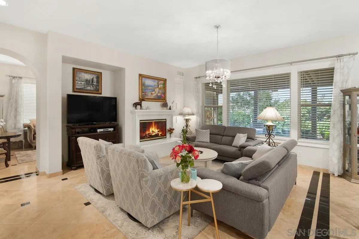 Undisclosed Address San Diego, CA 92130 - Photo 7 of 28 a living room with furniture a flat screen tv and a fireplace