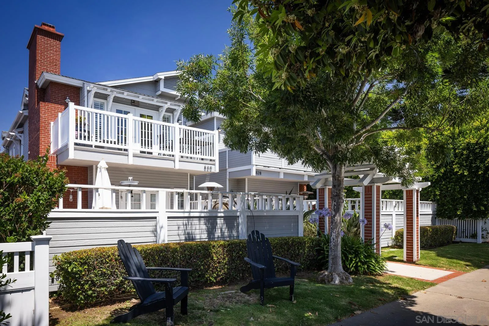 828 D Coronado, CA 92118 - Photo 2 of 24 a front view of a house with a garden and sitting area