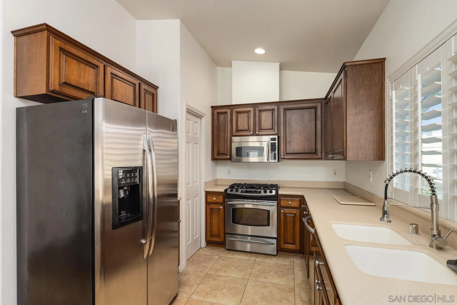 828 D Coronado, CA 92118 - Photo 10 of 24 a kitchen with stainless steel appliances granite countertop a refrigerator sink and stove