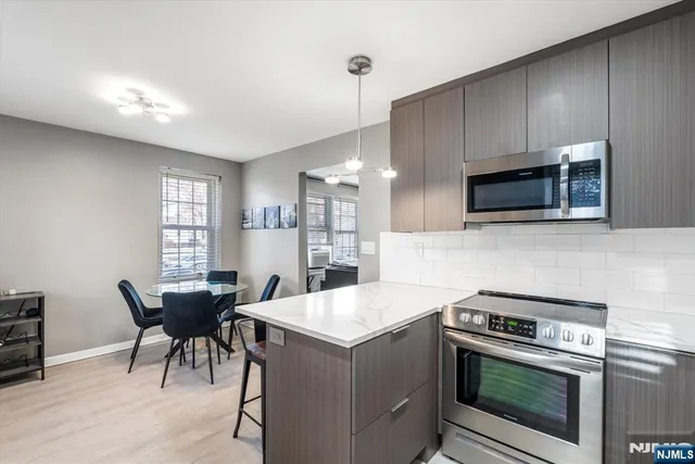 a kitchen with a stove a sink and a microwave