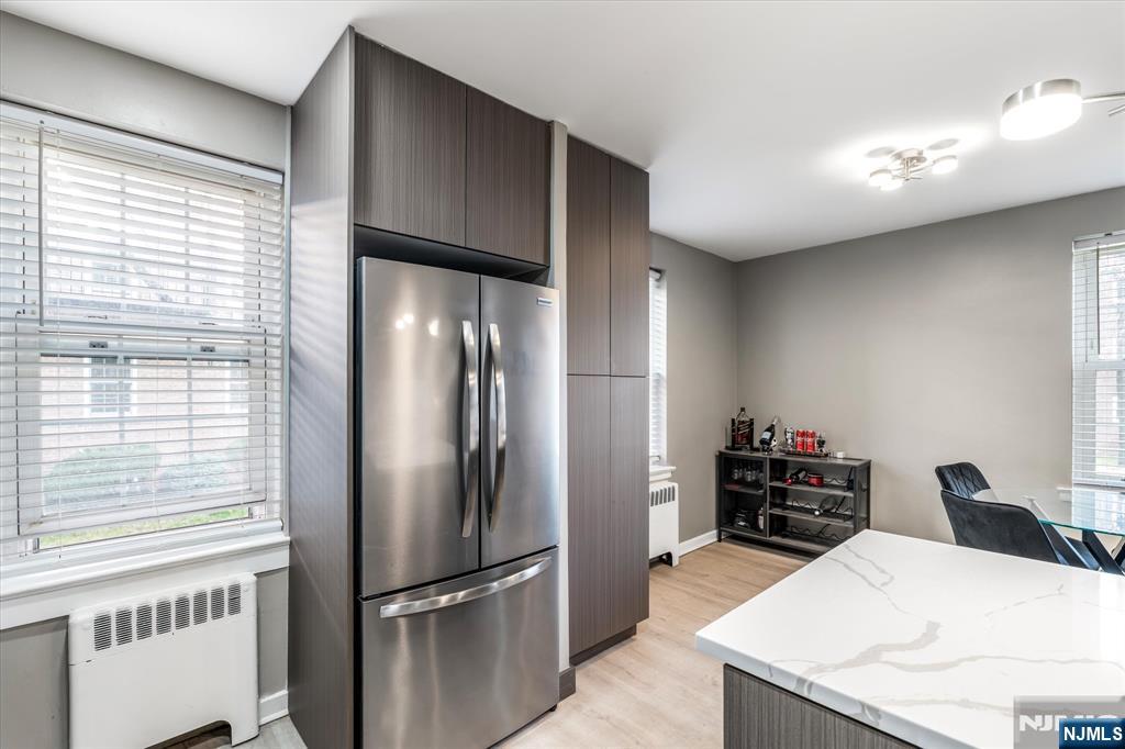 126 Hackett Place, Unit 101A Rutherford, NJ 07070 - Photo 15 of 22 a kitchen with stainless steel appliances kitchen island granite countertop a refrigerator and a stove top oven