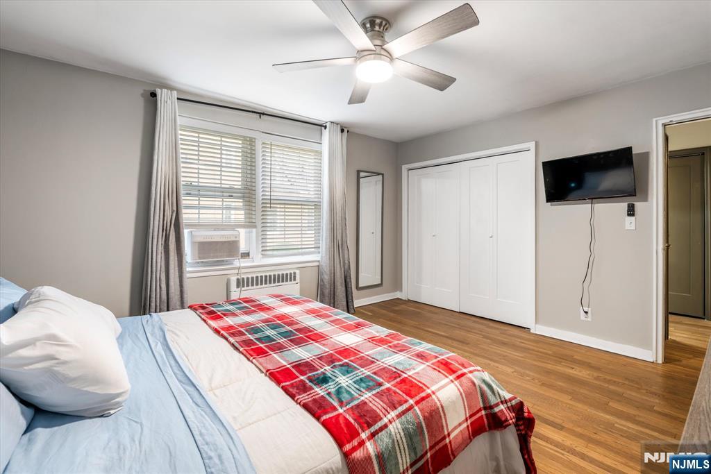 126 Hackett Place, Unit 101A Rutherford, NJ 07070 - Photo 18 of 22 a bedroom with a large bed and a chandelier