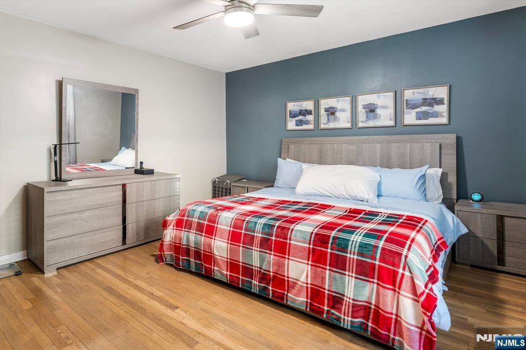 126 Hackett Place, Unit 101A Rutherford, NJ 07070 - Photo 19 of 22 a bedroom with a bed and a chandelier