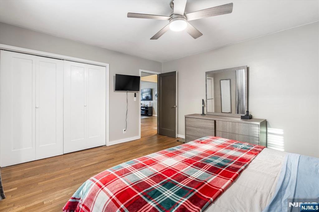 126 Hackett Place, Unit 101A Rutherford, NJ 07070 - Photo 20 of 22 a bedroom with a bed and a chandelier