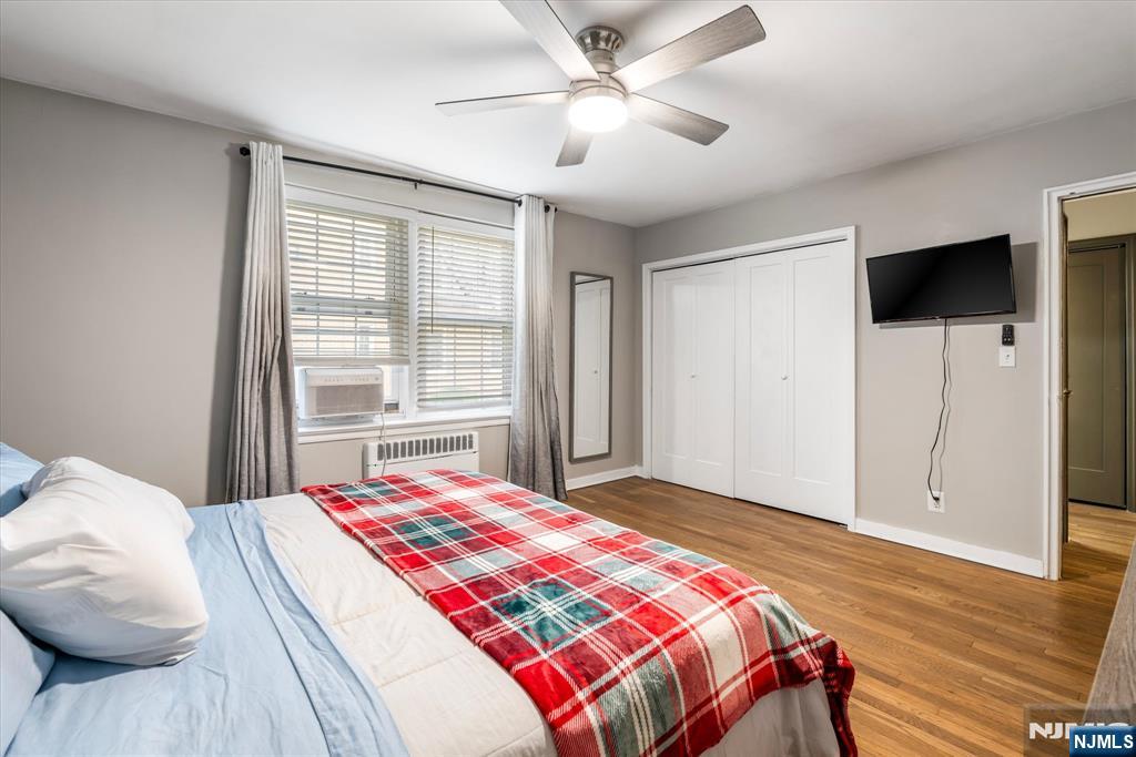 126 Hackett Place, Unit 101A Rutherford, NJ 07070 - Photo 21 of 22 a bedroom with a large bed and a chandelier