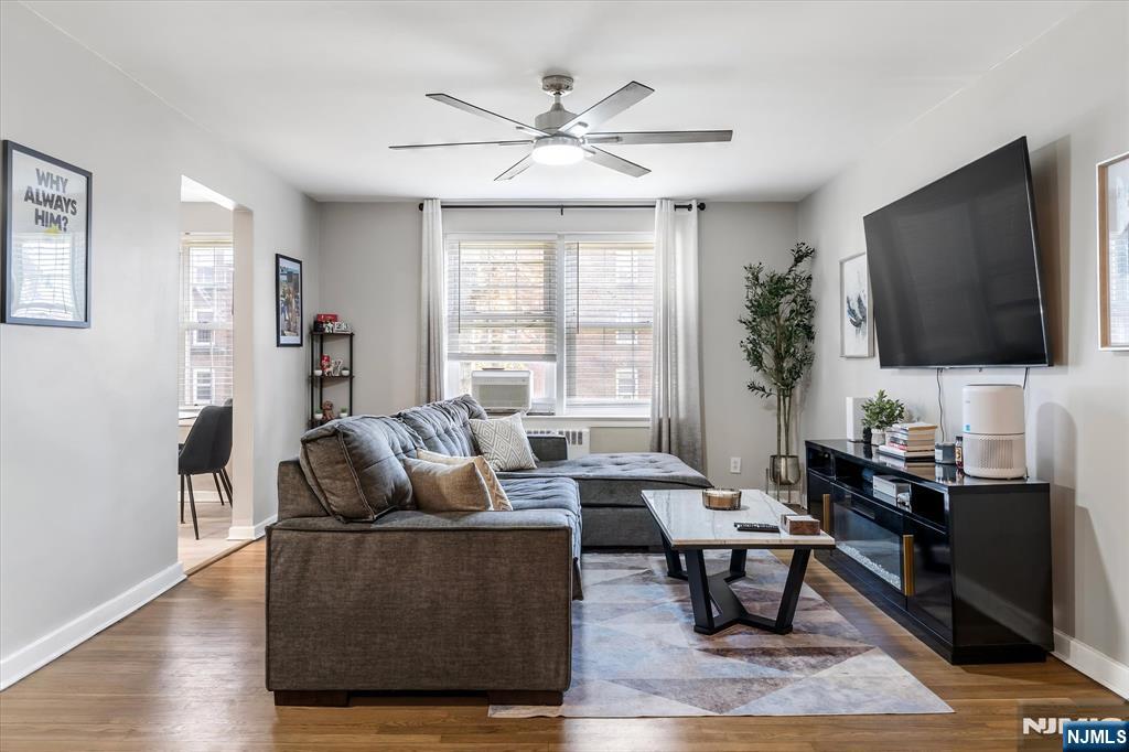 126 Hackett Place, Unit 101A Rutherford, NJ 07070 - Photo 7 of 22 a living room with furniture floor to ceiling window and wooden floor